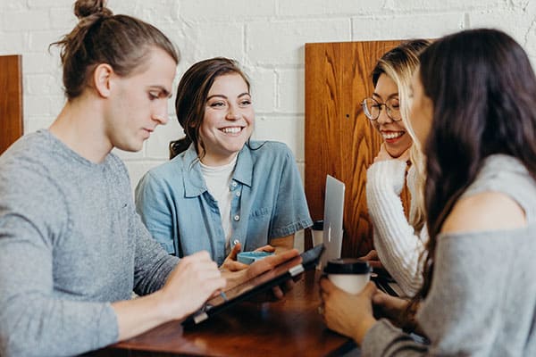 group of friends working at a coffee shop