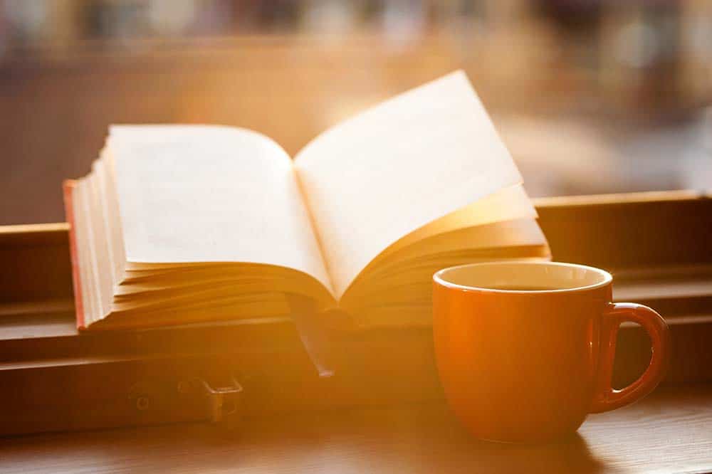Importance of Reading as a Business Leader - book with coffee